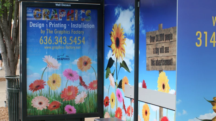 Bus shelter advertising panel with installed print graphics in St. Louis