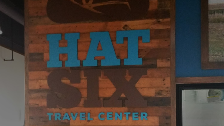 Hat 6 Travel Plaza interior with custom themed wall coverings and signage