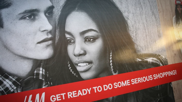 H&M storefront window graphics installed at a St. Louis mall location